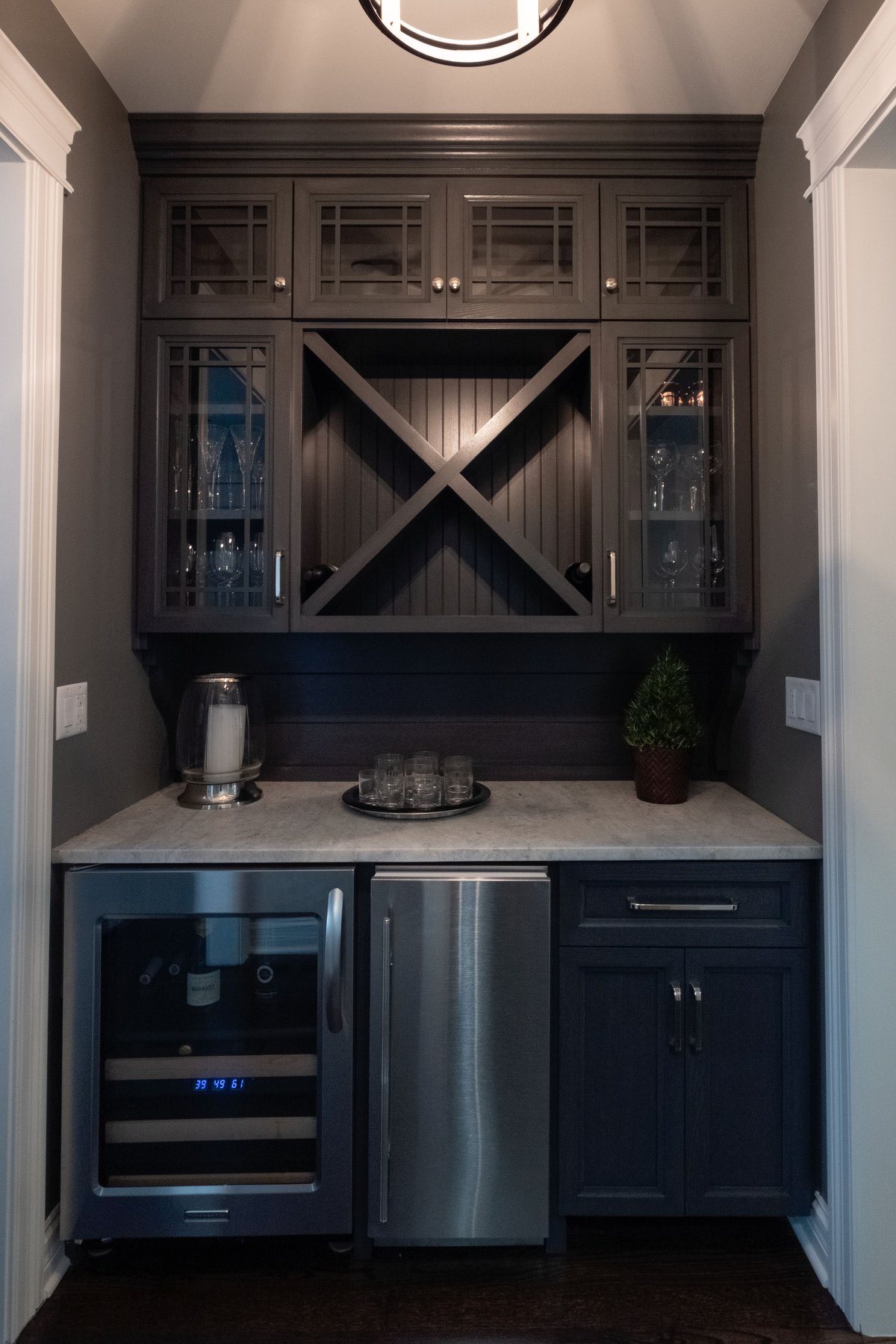 Custom dark grey wine and wet bar in a complete kitchen upgrade by Fears Construction featuring B Design.