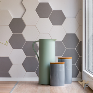 Hexagon-shaped geometric tiles in neutral tones create a bold statement in a modern kitchen design.