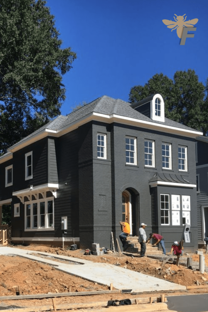 Dark gray brick house with a modern design.